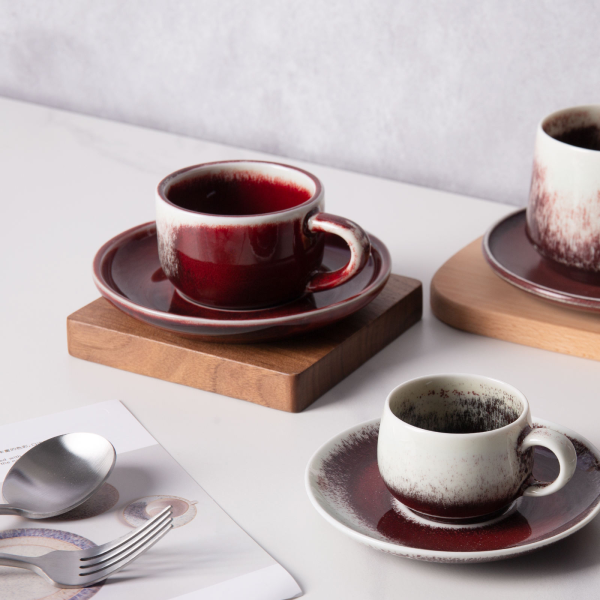 Festive red ceramic cups and plates for European-style afternoon tea or coffee