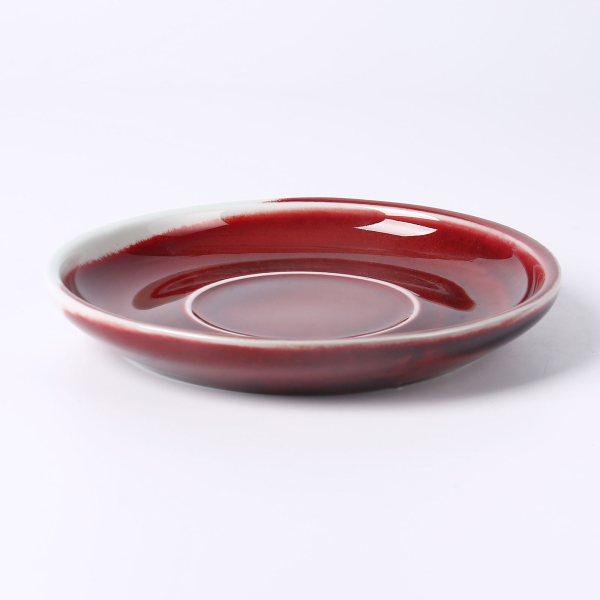Festive red ceramic cups and plates for European-style afternoon tea or coffee